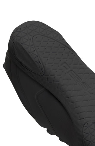 Close-up of a black cheer shoe with textured surface on a white background